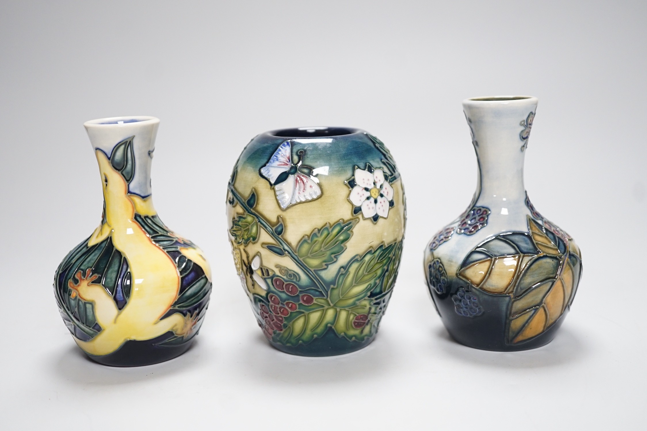 Three boxed Moorcroft small vases, Rarotonga Lizard, Bramble, etc., tallest 10 cm